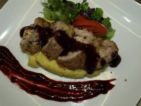 Panko crusted veal crab stuffed scaloppini w/ curried mango hominy grits and blackberry wine sauce
