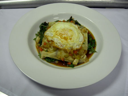Slow Braised 'Le Quebecois' Veal Cheek and Sweet Bread Raviolo with Roasted Root Vegatables, Swiss Chard, Sugo Arrosto, and a Fried Egg 